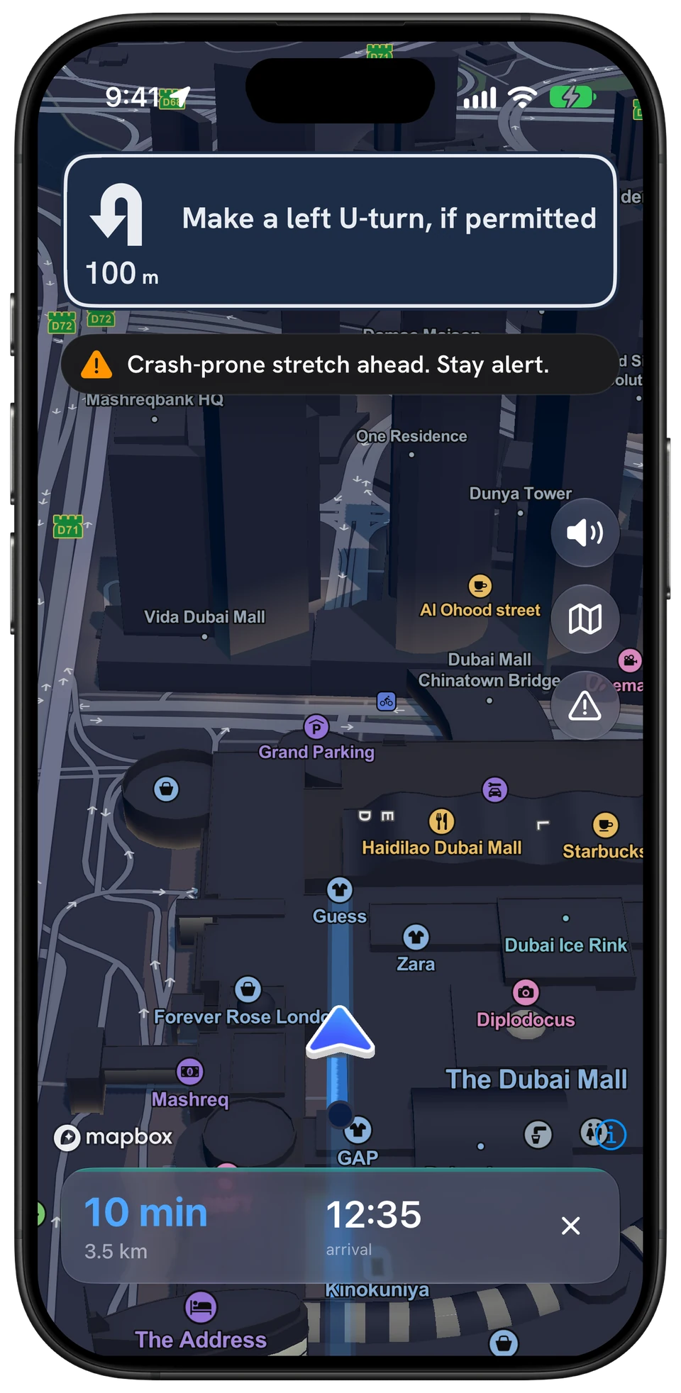 Phone navigation in Downtown Dubai: a U-turn card and Crash-prone stretch ahead. Stay alert.